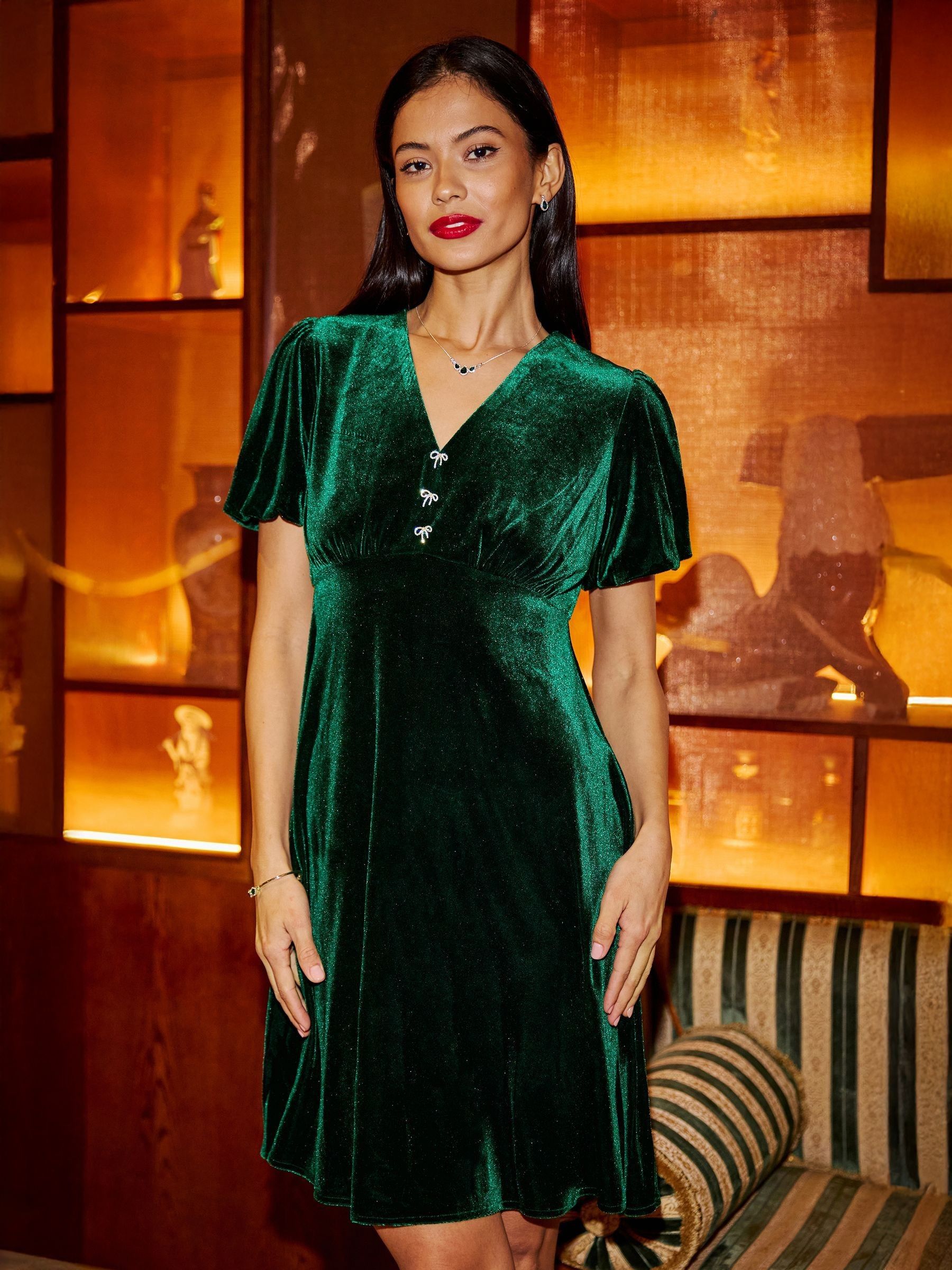 Buy Yumi Green Velvet Skater Dress With Dimante Bow Detail from