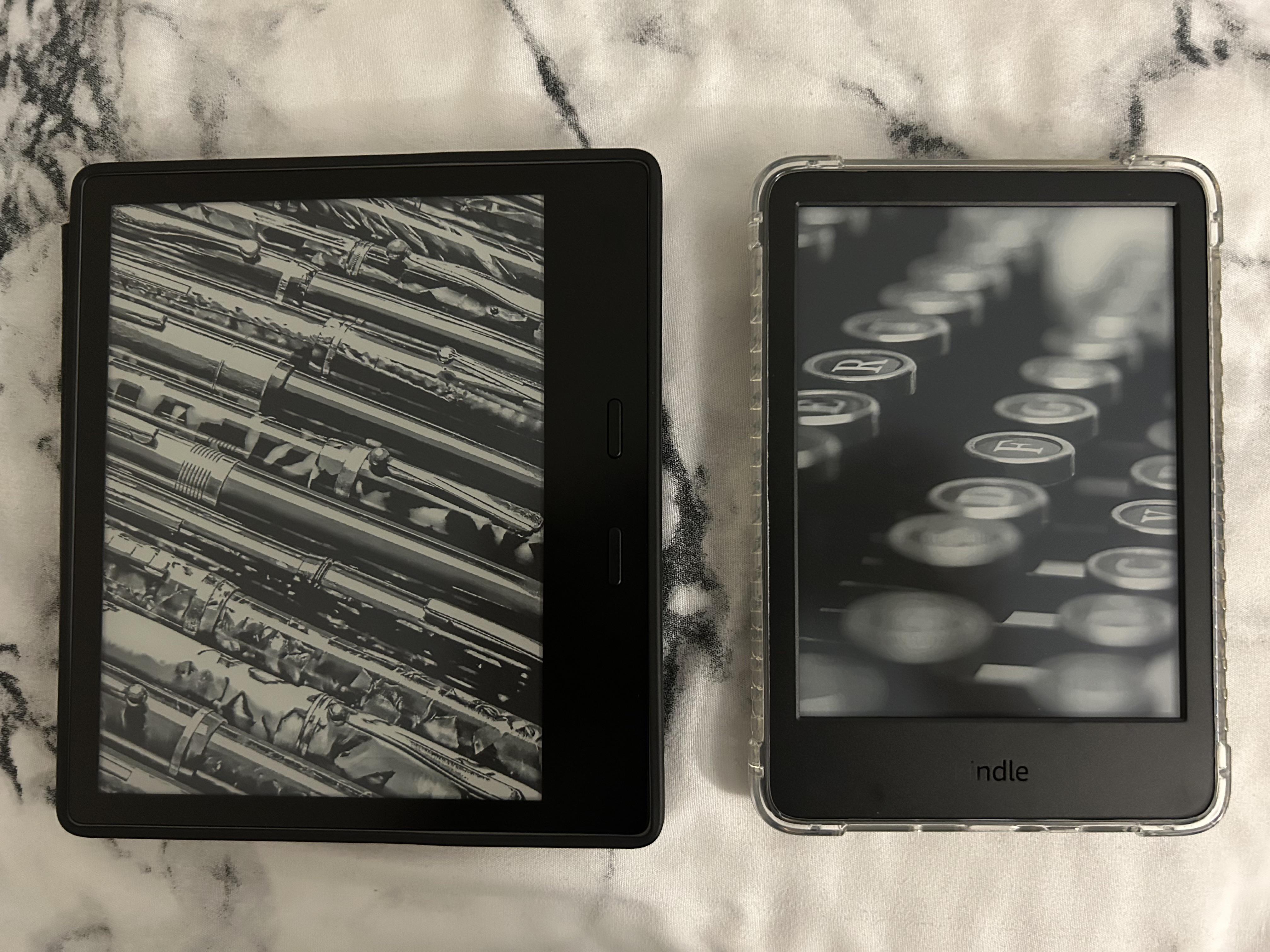 My Kindle Oasis 9th Gen beside my newly acquired Kindle Basic 2022